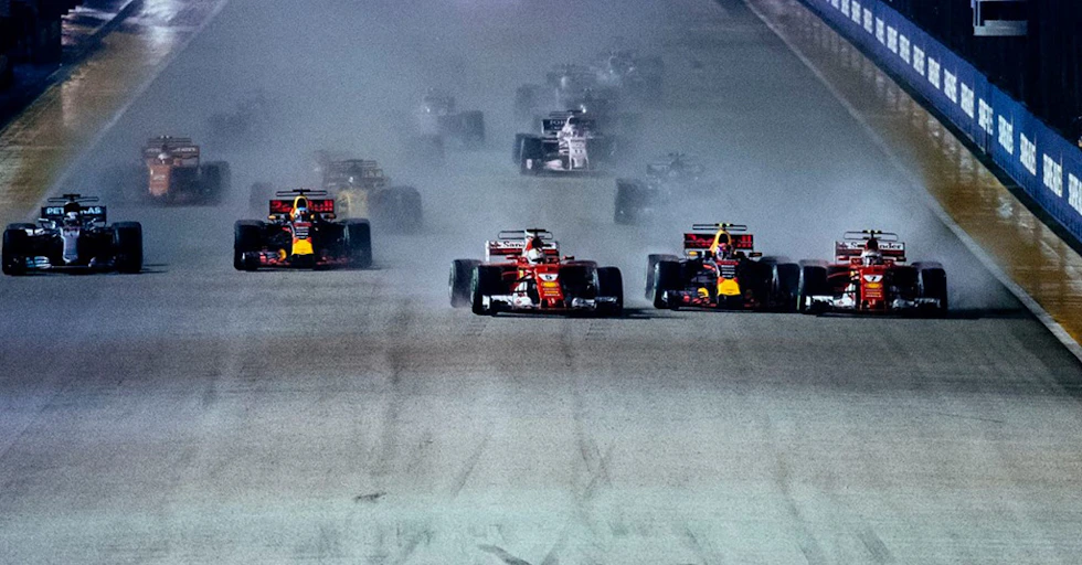 The two Ferrari's of Sebastian Vettel and Kimi Raikkonen pinch Max Verstappen as the trio collides, sending each out of the race.