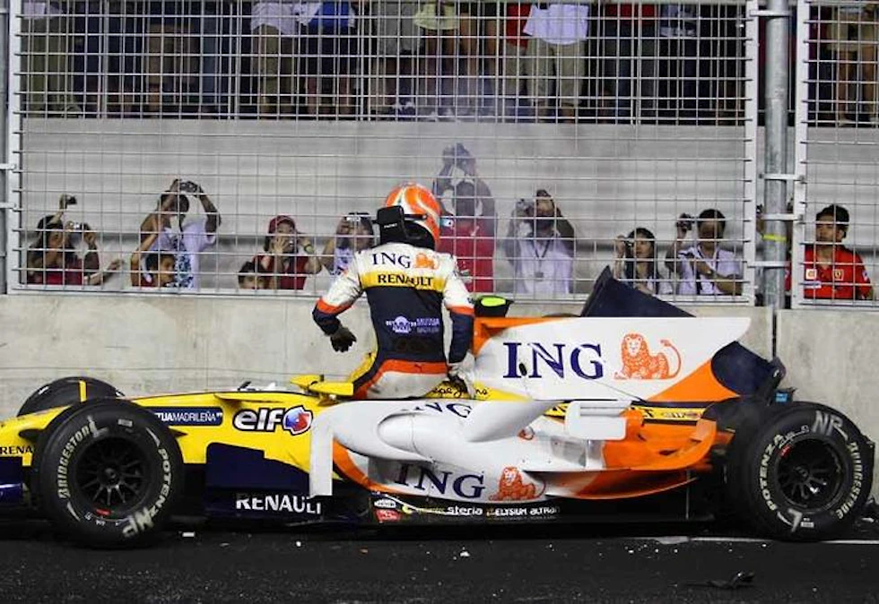 Alonso's teammate steps out of his ruined Renault after crashing.